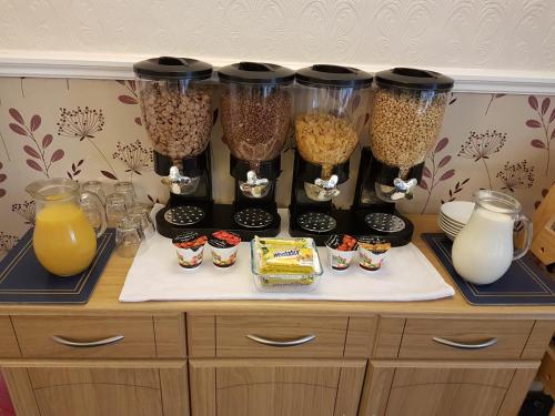 a counter with a bunch of containers of food at Tobermory Hotel in Blackpool