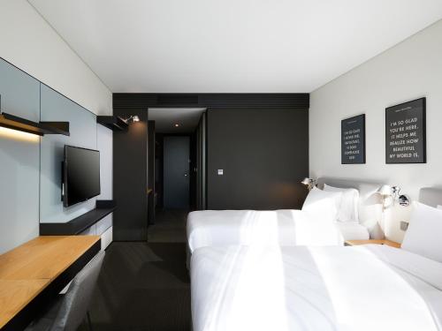 Letto o letti in una camera di GLAD Mapo