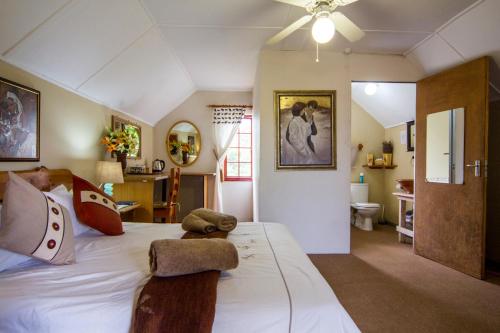 a bedroom with a bed with two stuffed animals on it at 40 Fraser Street Bed and Breakfast in Howick