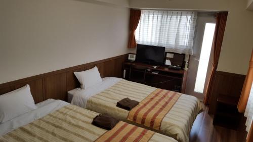 Ένα ή περισσότερα κρεβάτια σε δωμάτιο στο Hotel Peacely In Miyakojima Nexus