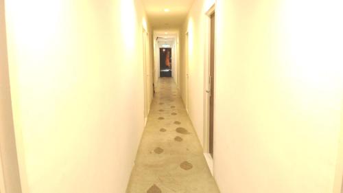 an empty hallway with a long corridor at Apple 1 Hotel Gurney in George Town