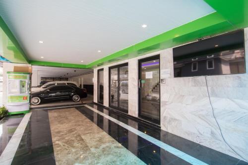 a garage with a car parked in a parking lot at B-your home Hotel Don Mueang Airport Bangkok 如你家酒店 in Bangkok