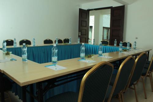 a conference room with a long table with water bottles on it at Jacaranda Indian Ocean Beach Resort in Diani Beach