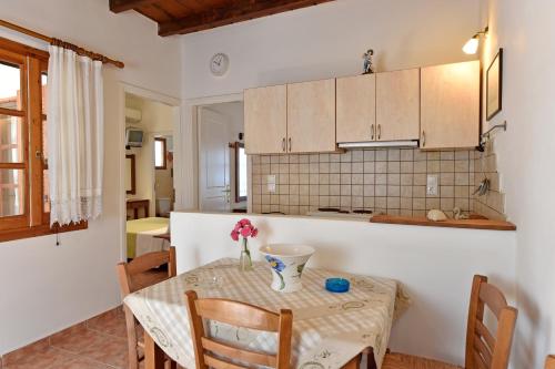 a kitchen with a table with a vase on it at Hippocampus Studios in Antiparos Town