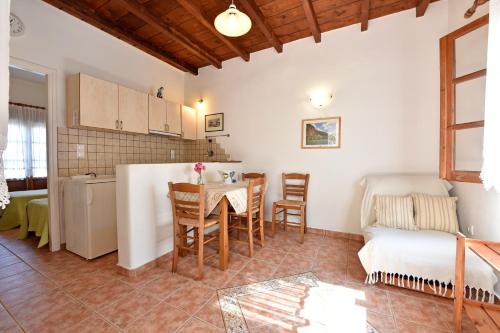 a kitchen and living room with a table and a couch at Hippocampus Studios in Antiparos Town
