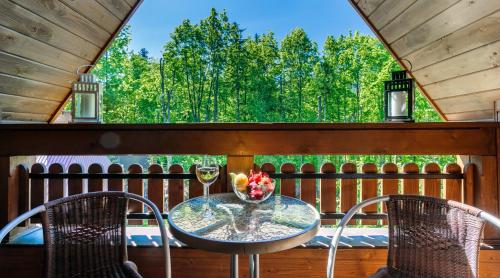 a table and chairs on a porch with a view of trees at Rent like home - Tetmajera in Zakopane