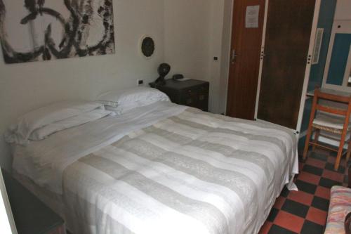 
a bedroom with a bed and a dresser at Hotel Gianni Franzi in Vernazza
