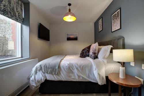a bedroom with a bed and a table at The Temple Inn in Temple Cloud