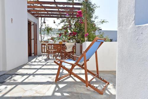 a chair sitting on a patio with a table at Hippocampus Studios in Antiparos Town