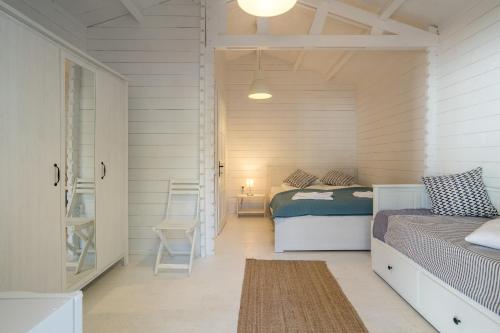 a bedroom with two beds and a hallway with a door at Casa De Mare in Olimp