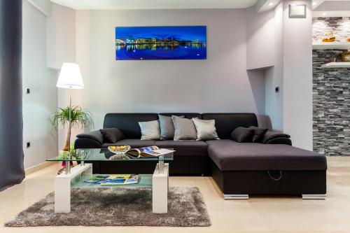 a living room with a couch and a table at Gold & Silver Apartments in Brna