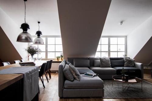 a living room with a couch and a table at Apartamenty Rynek 10 in Bielsko-Biala