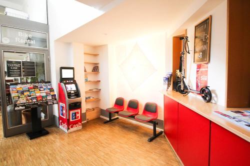 a gas station with two red chairs and a machine at THE 4YOU Hostel & Hotel Munich in Munich