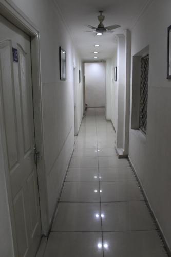 a hallway with white walls and a ceiling at Deccan Comforts in Hyderabad