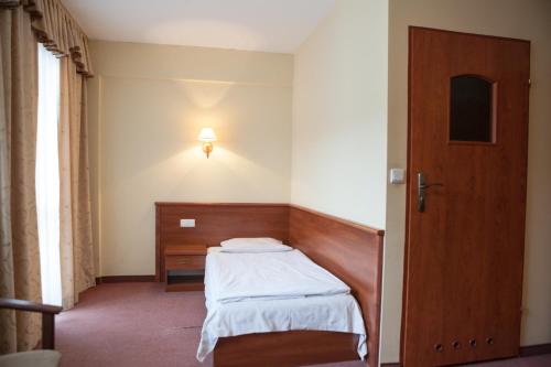 
Łóżko lub łóżka w pokoju w obiekcie Hotel Przedwiośnie

