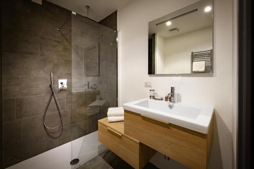 a bathroom with a sink and a shower at Eco Rooms&Breakfast Tirano in Tirano