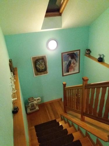 a room with a staircase with a blue wall at Villa Holiday in Karlovy Vary