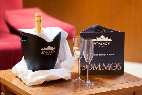 a table with two glasses and a bottle of champagne at SOMMOS Hotel Benasque Spa in Benasque