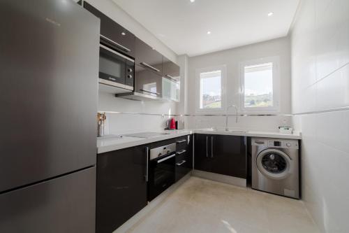 a kitchen with a washing machine and a washer at Mnar Castle in Tangier