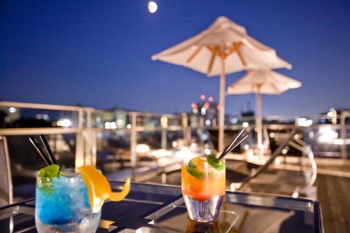 two cocktails sitting on a table on a balcony at The Screen in Kyoto