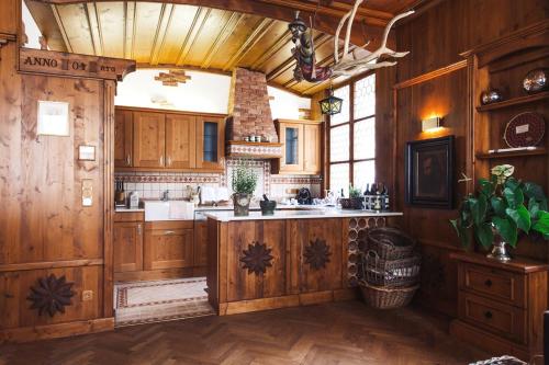 a kitchen with wooden cabinets and a large kitchen island at Sandwirth Suites Palais Musil in Klagenfurt