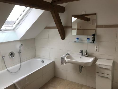 a bathroom with a bath tub and a sink at Hotel Ristorante Milano in Bad Tölz