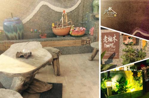 a room with a wooden table with a boat on it at Home & Teak Homestay in Jinning