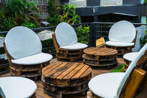 a group of chairs and tables on a deck at Riande Urban Hotel in Panama City