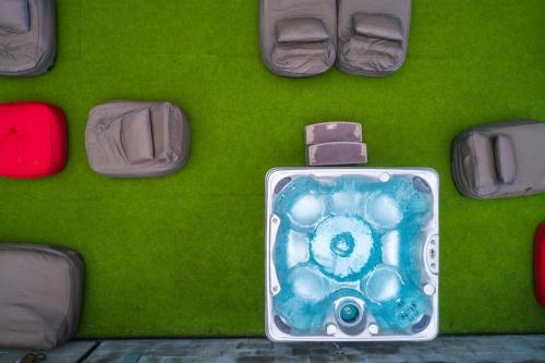 a green floor with shoes and a suitcase on it at Riande Urban Hotel in Panama City