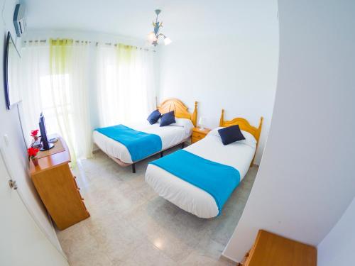 Posteľ alebo postele v izbe v ubytovaní Homely Apartments Club Nautico