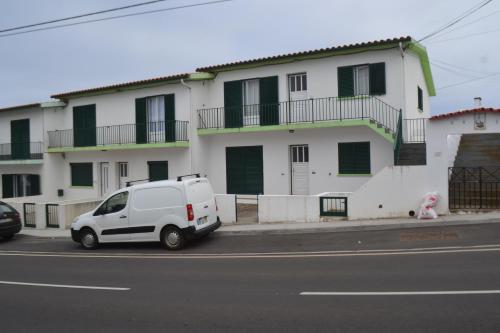 a white van parked in front of a building at TINA - AL Praia da Vitória - RRAL 759 in Praia da Vitória