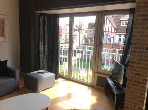 a living room with a large sliding glass door at James D in De Haan