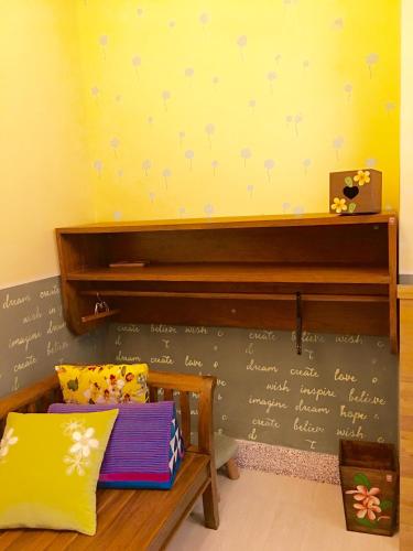 a classroom with a bench and a wall with writing on it at Home & Teak Homestay in Jinning