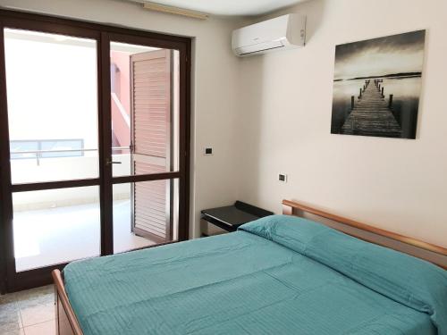a bedroom with a bed and a large window at Villa Dora in Grado