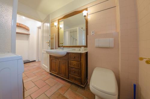a bathroom with a sink and a toilet and a mirror at Casa del Sole in Finale Ligure