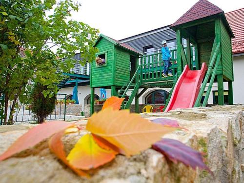 a playground with a green house and a slide at Katarzynka in Boleścin