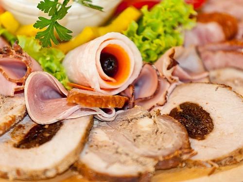 a plate of food with meat and mushrooms and vegetables at Katarzynka in Boleścin