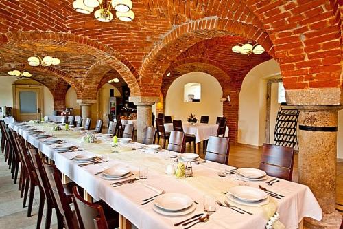 a long dining room with white tables and chairs at Katarzynka in Boleścin