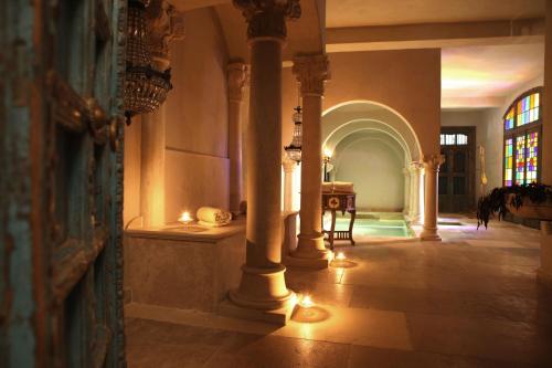 a hallway with columns and a table in a building at Jardins Secrets in Nîmes