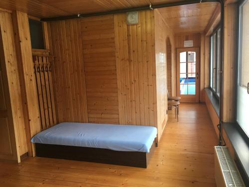 een slaapkamer met een bed in een houten kamer bij Penzion Kycera in Oščadnica