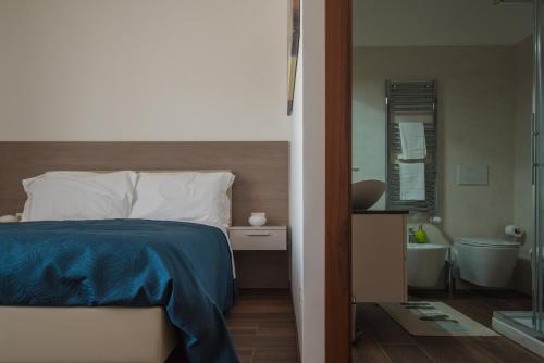 a bedroom with a bed and a bathroom with a tub at Enjoy Milano Skyline in Milan