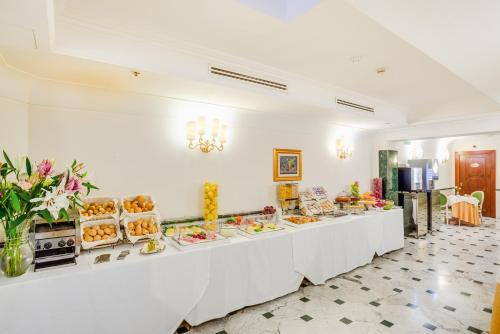 a buffet line with plates of food on it at Raeli Hotel Regio in Rome