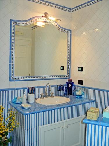a bathroom with a sink and a large mirror at Casa Mariannina in Maiori