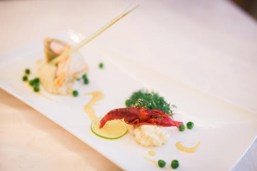 a plate of food with a shrimp and vegetables at Gasthof zum goldenen Löwen in Nauders