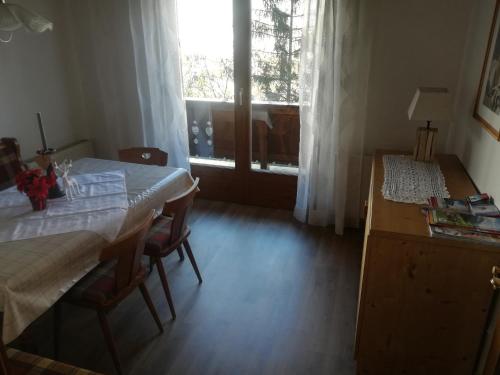 a dining room with a table and a window at Waldrast in Finkenberg