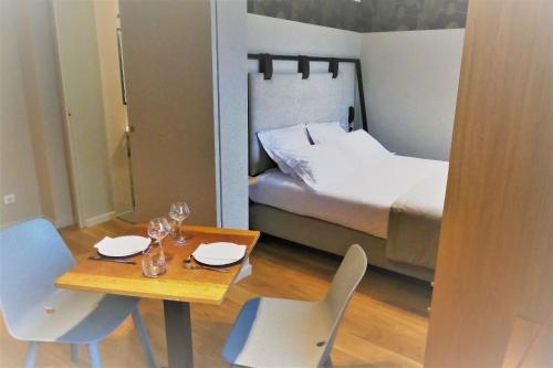 a room with a table and chairs and a bed at Aigle d'Or - Strasbourg Nord in Reichstett