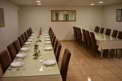 a long dining room with a long table and chairs at Guest House Regina Mundi in Međugorje