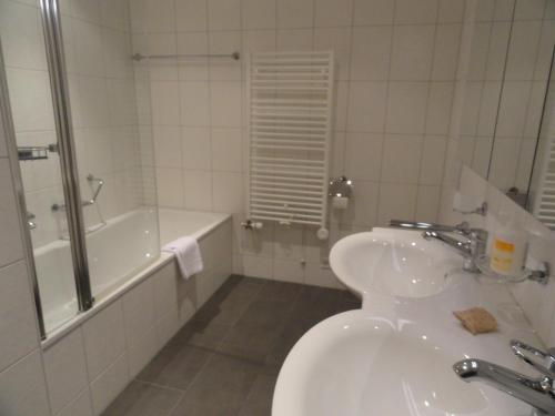 uma casa de banho com um lavatório, uma banheira e um WC. em Chalet Bella Vista 3 em Wengen