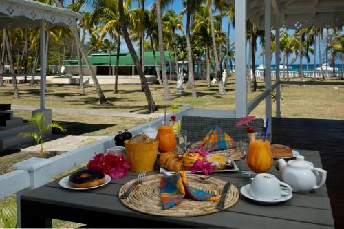a table with food and drinks on top of it at Bequia Plantation Hotel in Bequia
