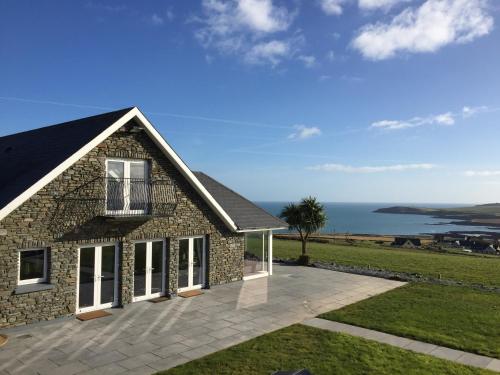 a stone house with a view of the ocean at Ocean View,Kinsale, Hosted by Exquisite holiday homes, sleeps 22 in Kinsale